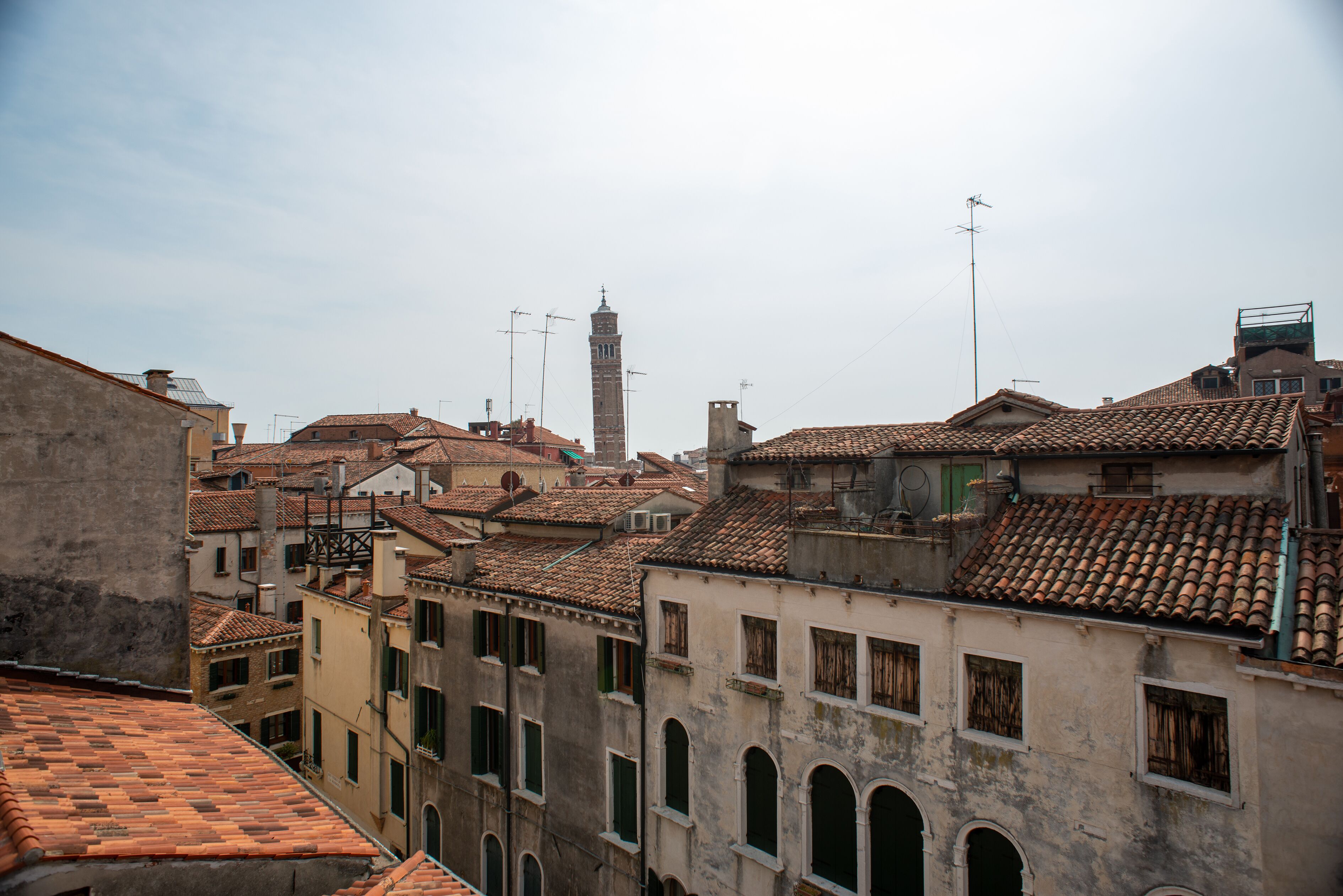 A historic urban area with traditional architecture, including buildings with tiled roofs and arched windows.