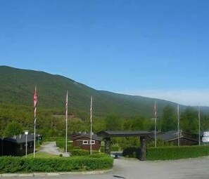 A mountain landscape with a small building and a covered area, likely a lodge or cabin. - Dovre Motell (Dovre)