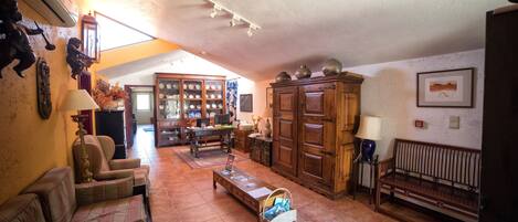 A spacious living room with a sofa, a coffee table, and a wooden cabinet.