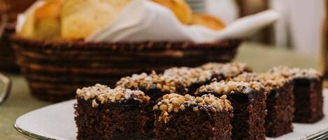 A plate of brownies with nuts on a table.