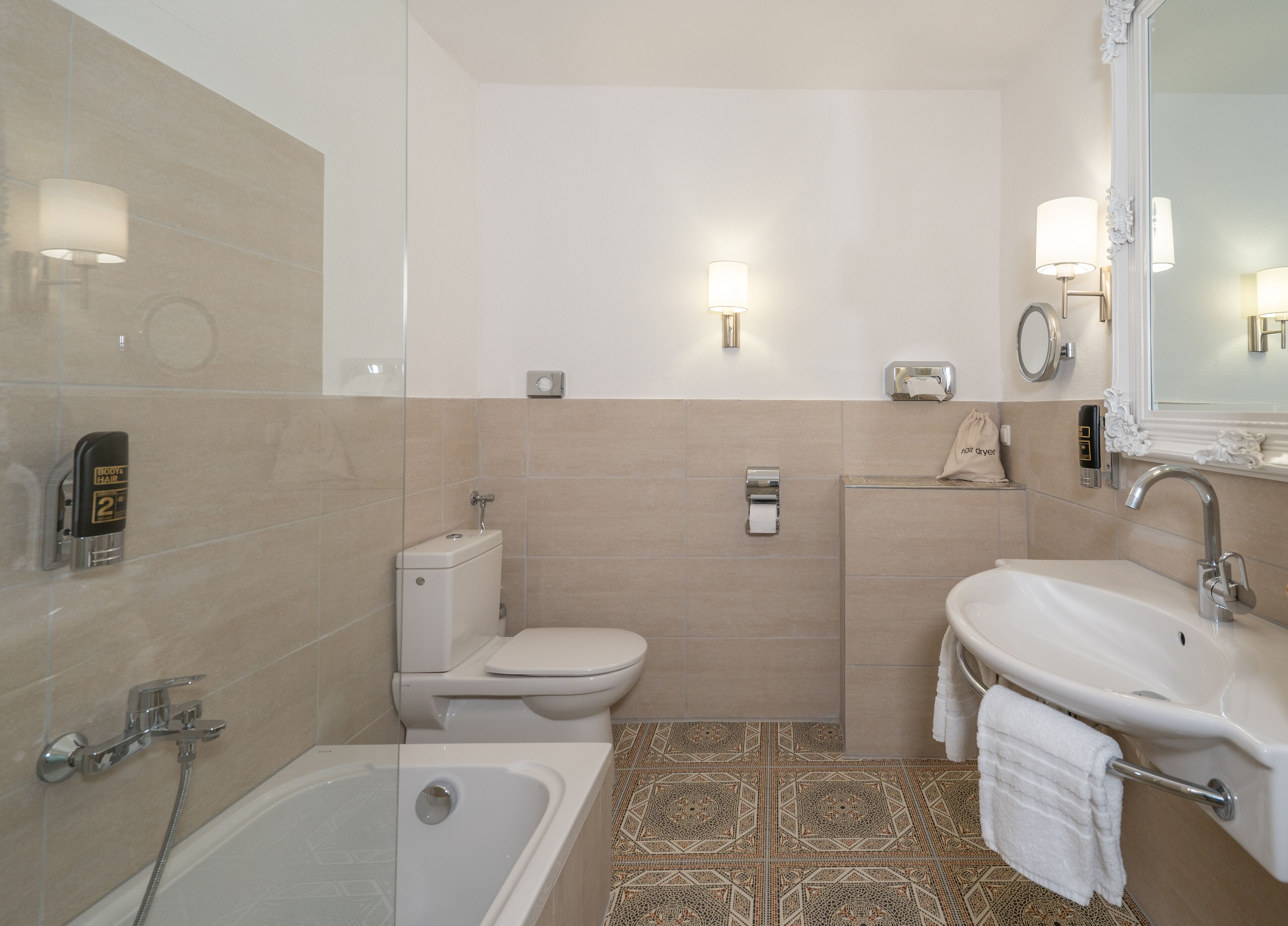 Uma casa de banho moderna com banheira, sanita e lavatório.