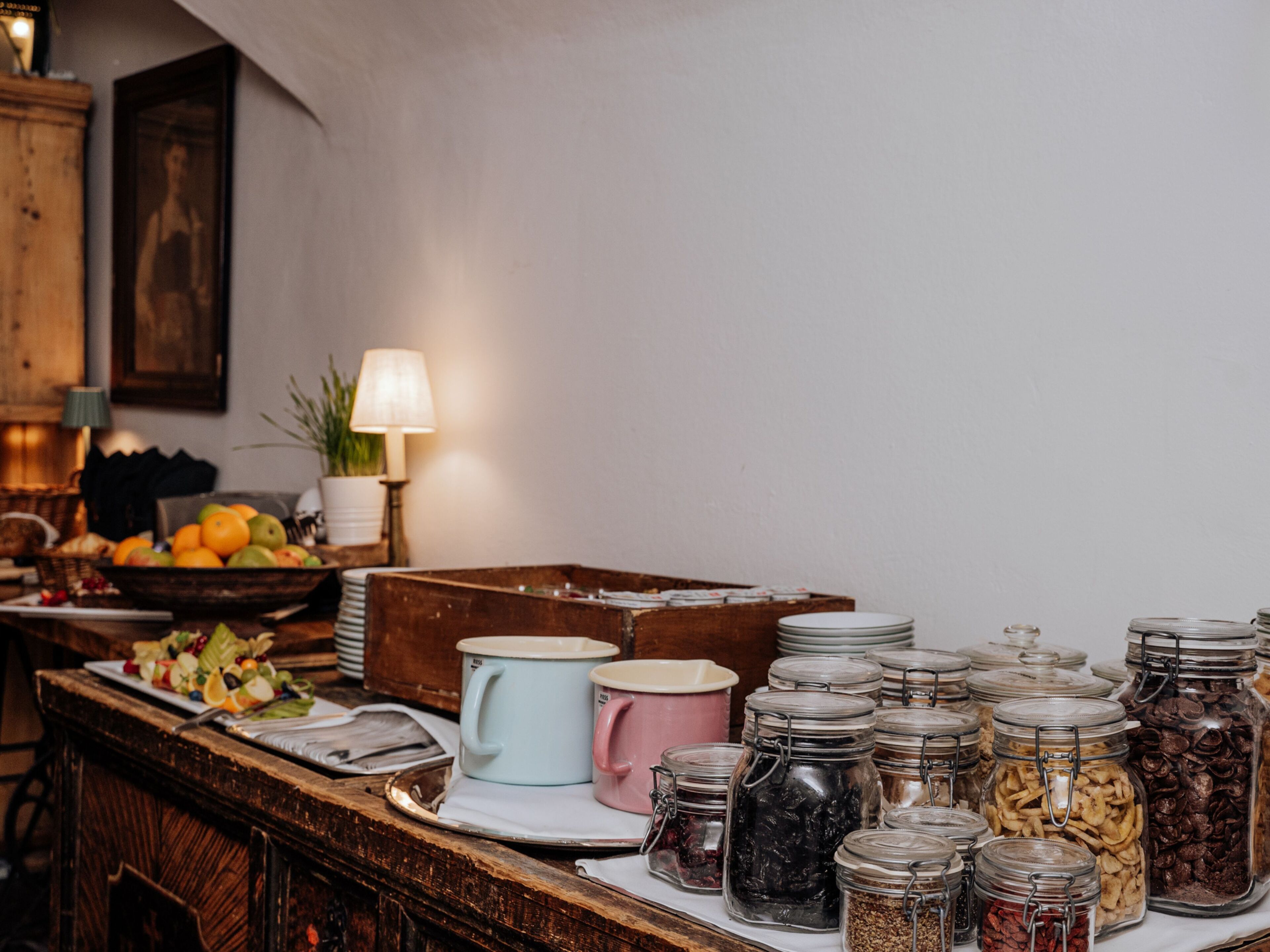 A buffet table with various food items and serving dishes.