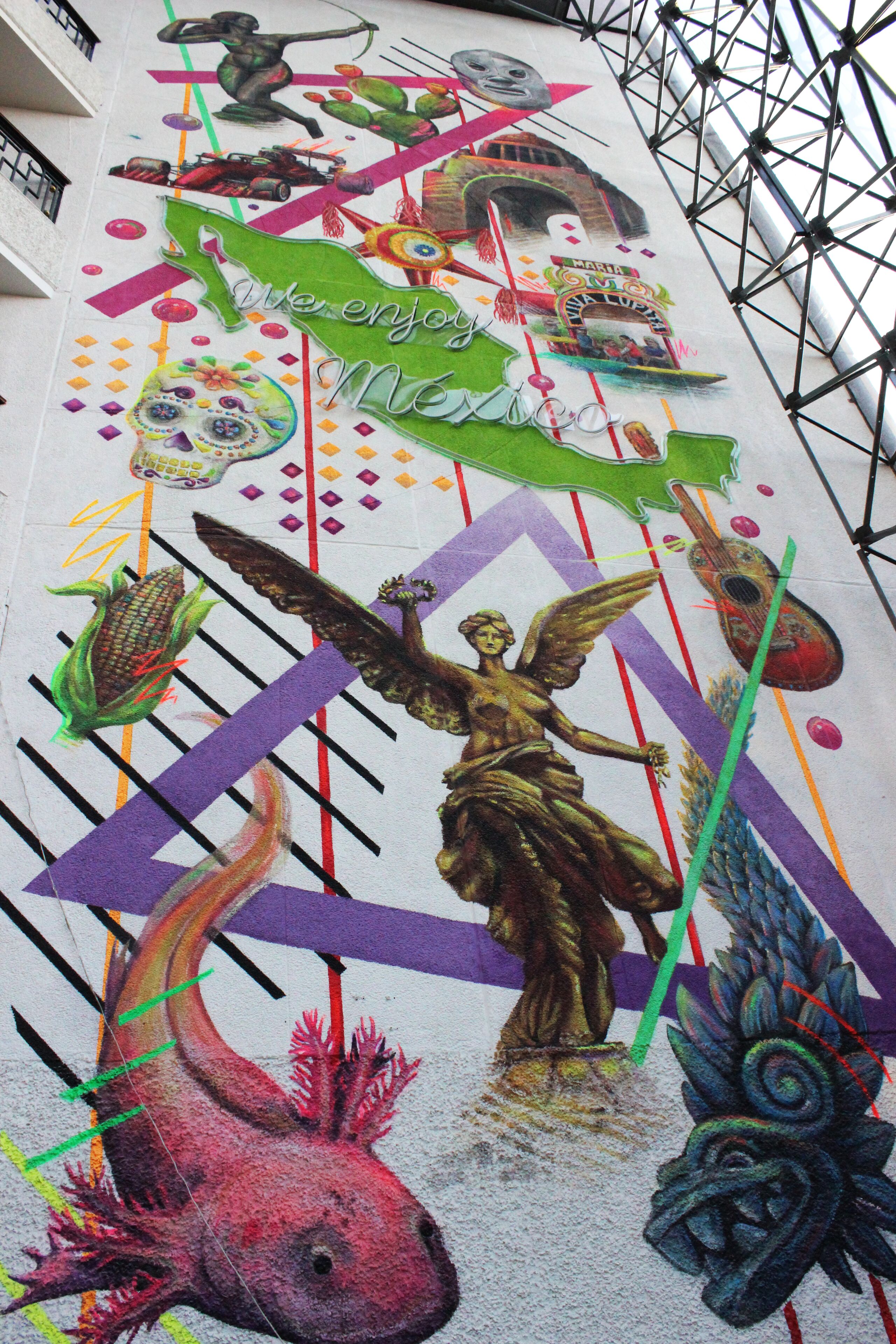 A mural with vibrant artwork including a figure of an angel, a fish, and a building.