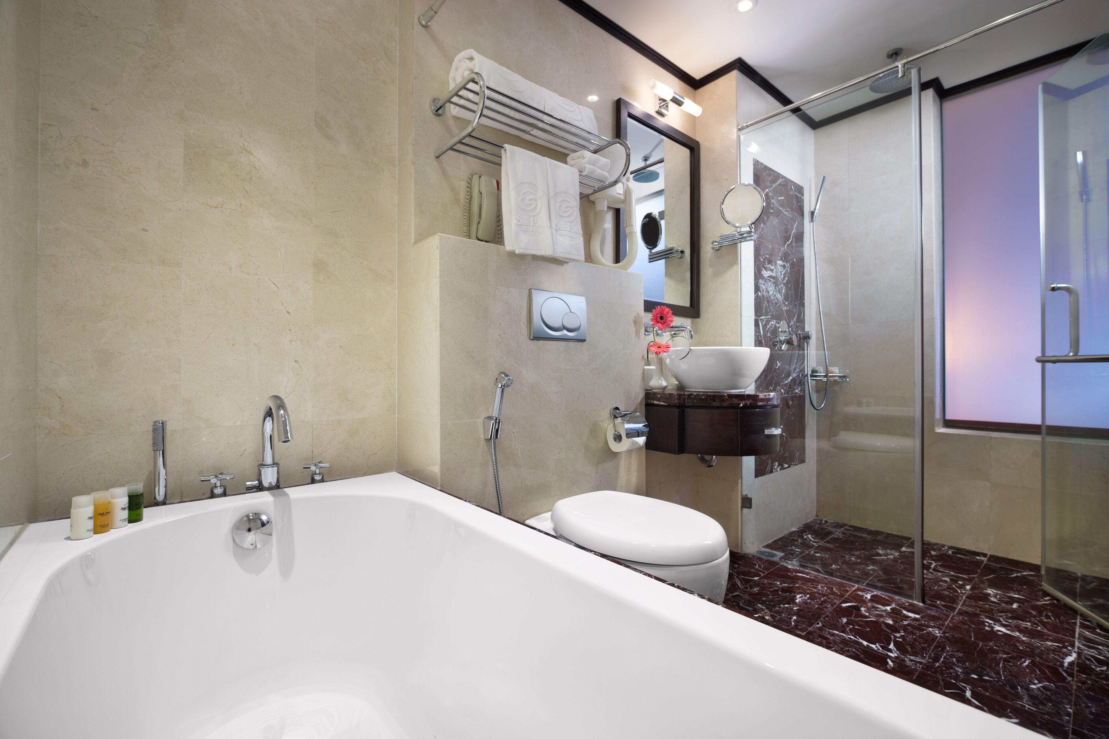 deep-soaking bathtub, rainfall showerhead, designer toiletries