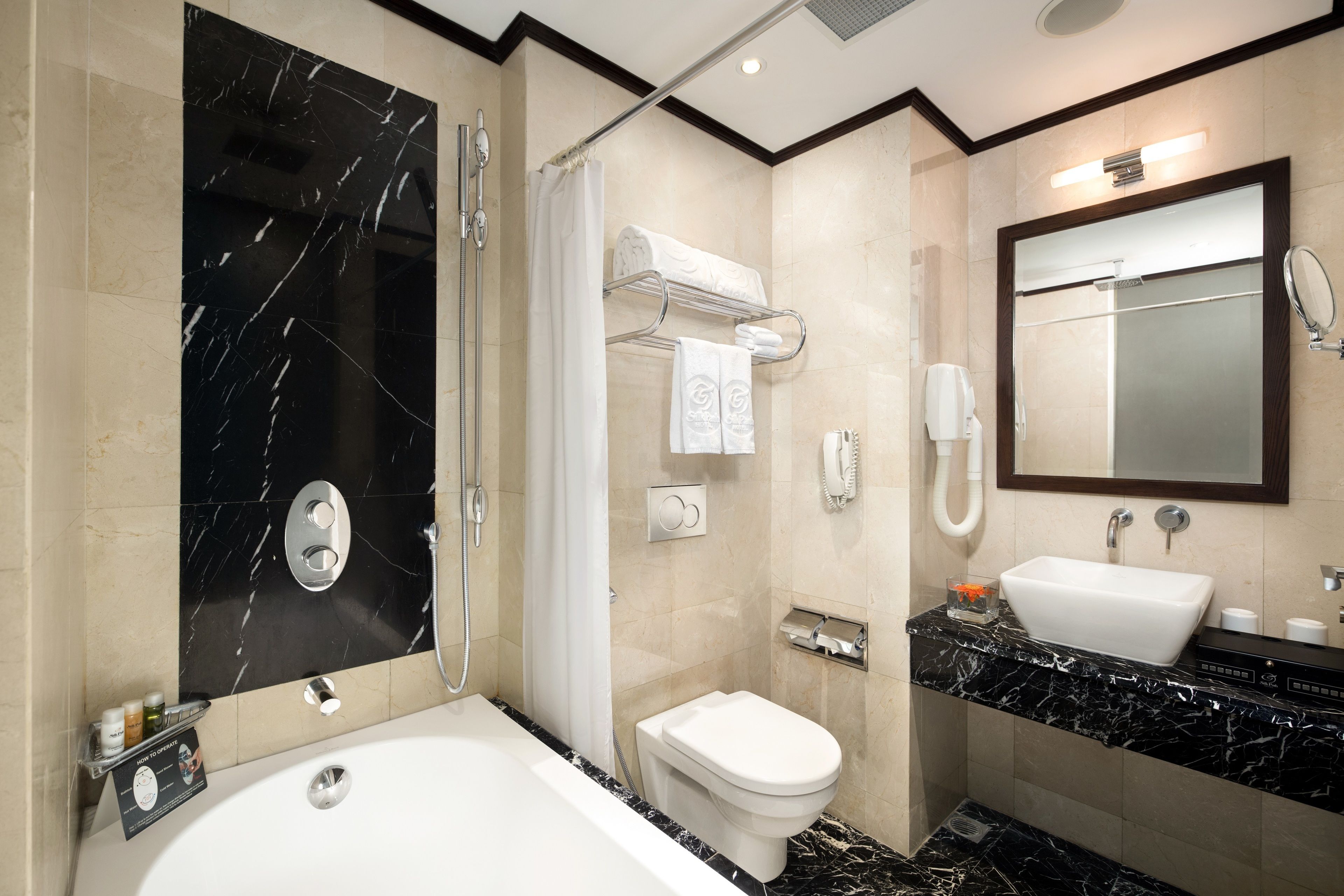 deep-soaking bathtub, rainfall showerhead, designer toiletries