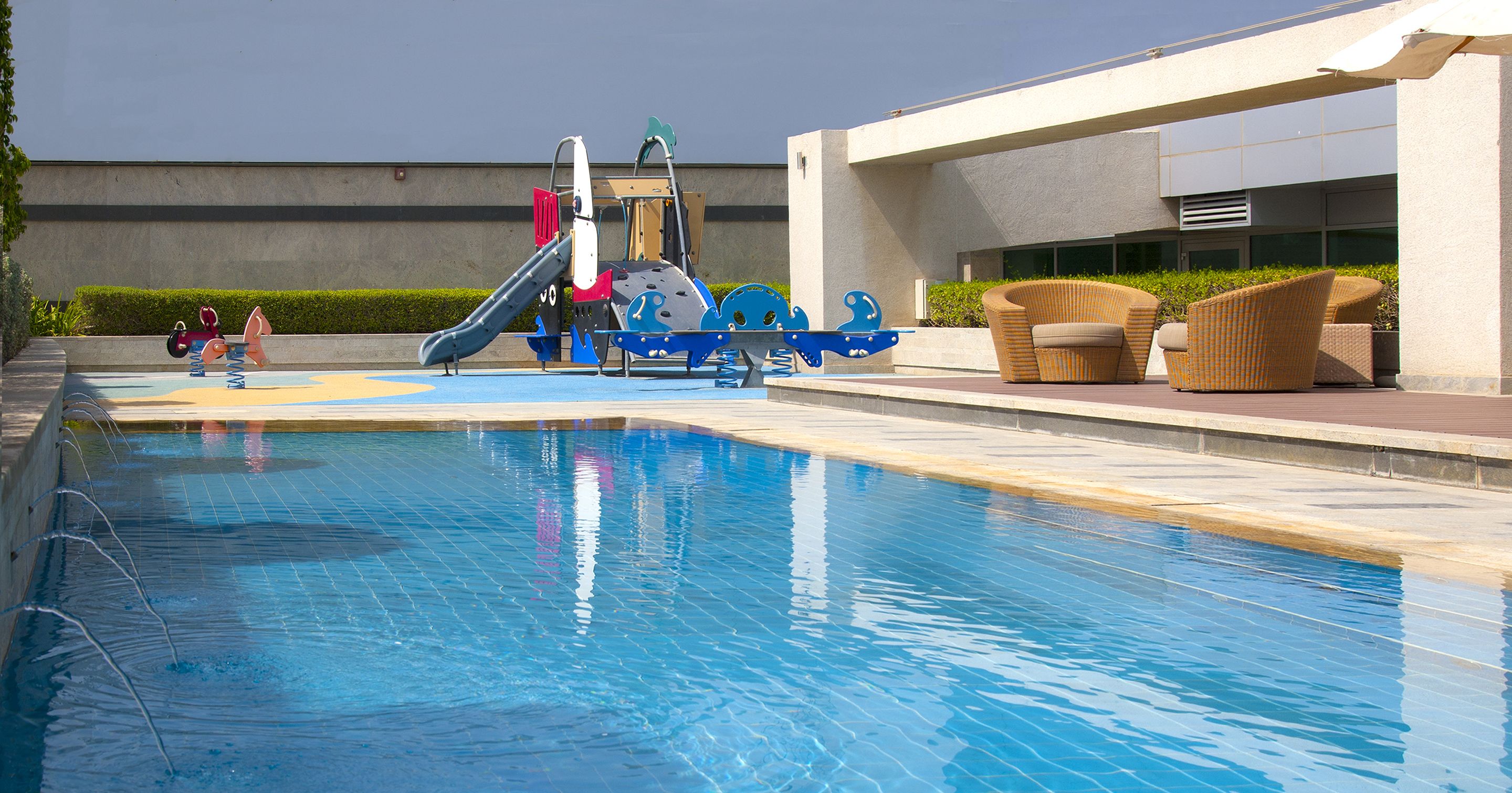 outdoor pool, open 8:00 am to 7:00 pm, pool umbrellas, pool loungers