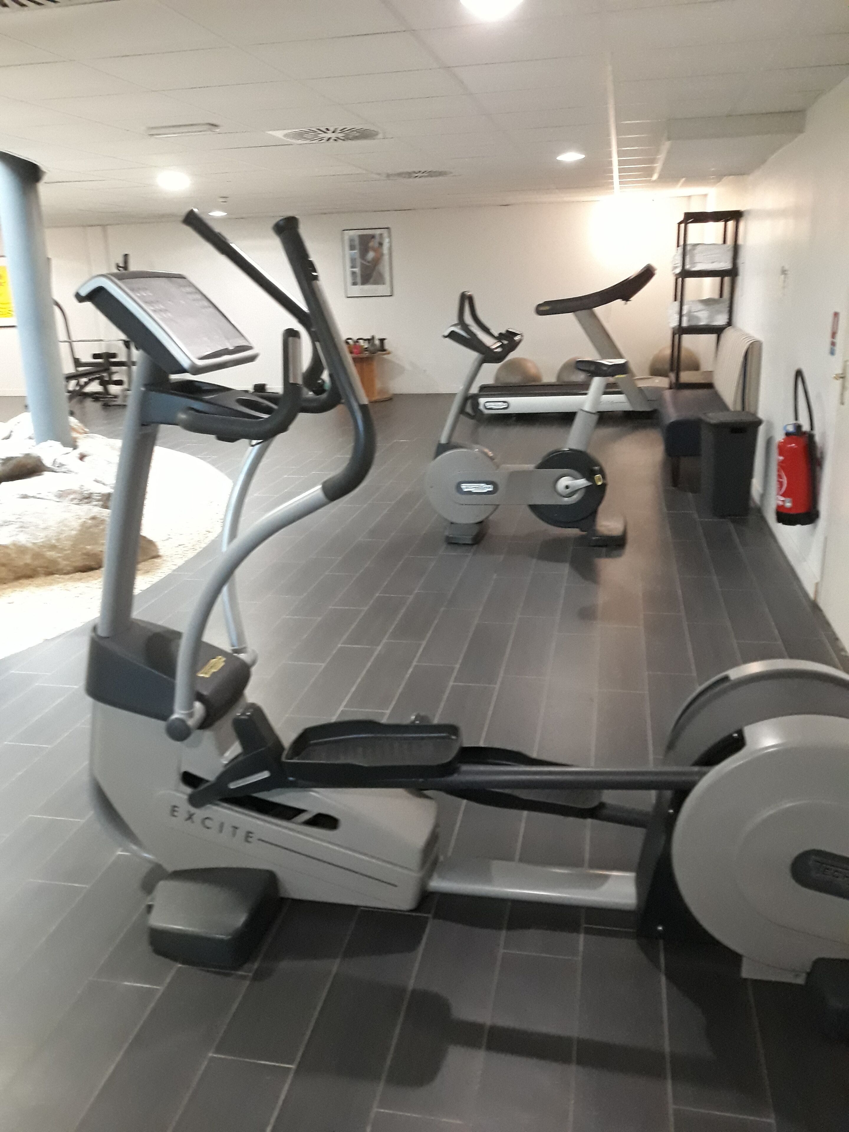 A gym with stationary bikes and treadmills.