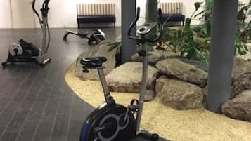 An indoor gym with stationary bikes and a seating area.