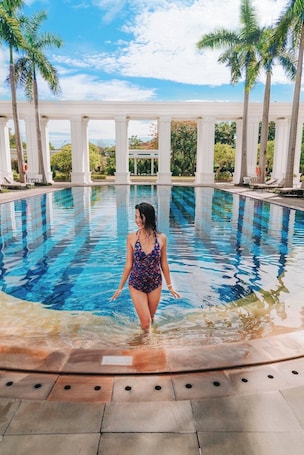 Outdoor pool, pool umbrellas, sun loungers. Indochine Palace