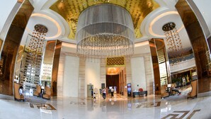 A spacious lobby with a large chandelier, high ceilings, and a modern design. - Asta Hotel (Shenzhen)