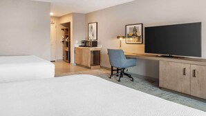 A hotel room with a bed, a desk with a chair, a TV, and a wardrobe. - Hilton Garden Inn Charlotte/Concord (Concord)