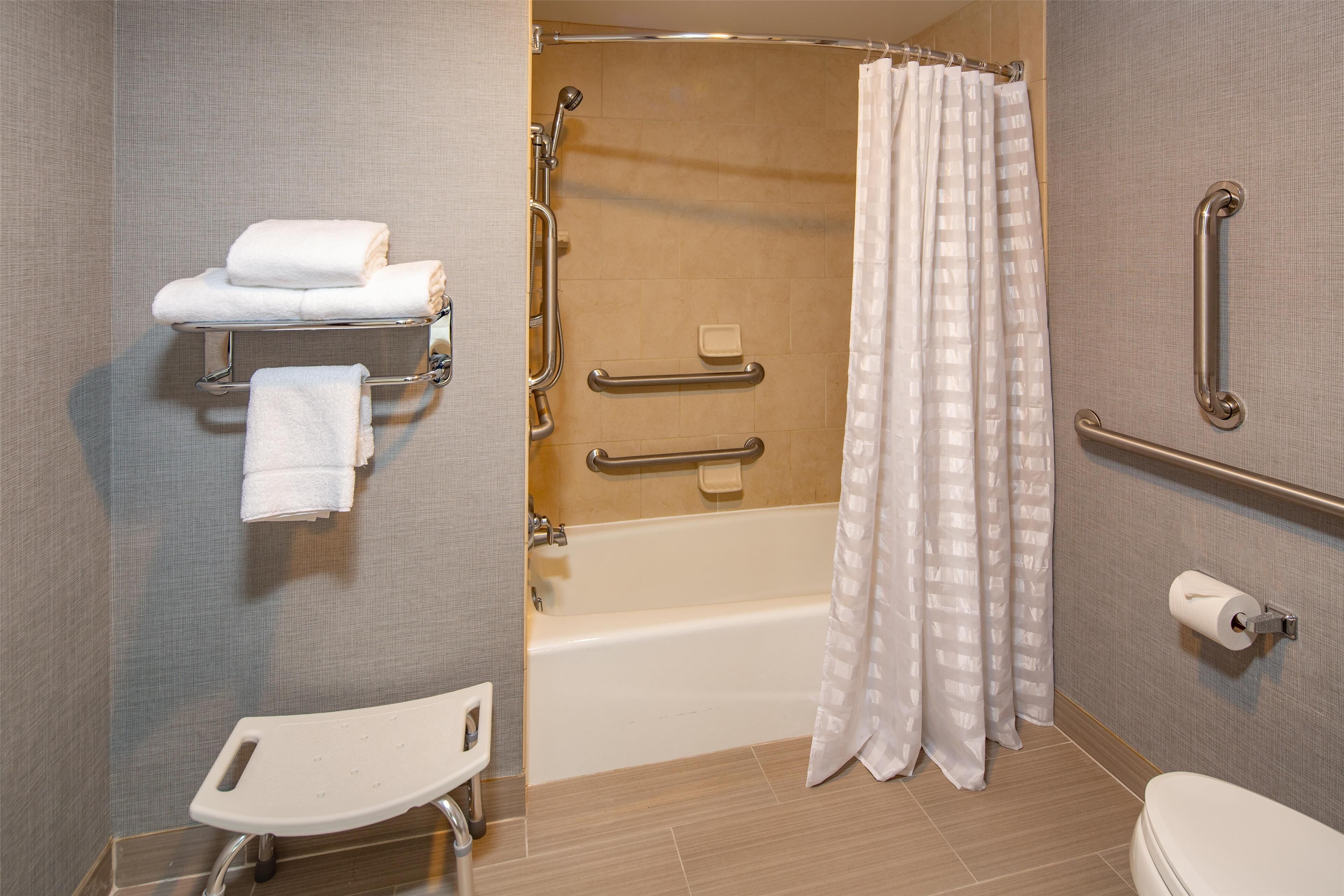 combined shower/bathtub, designer toiletries, hair dryer, towels