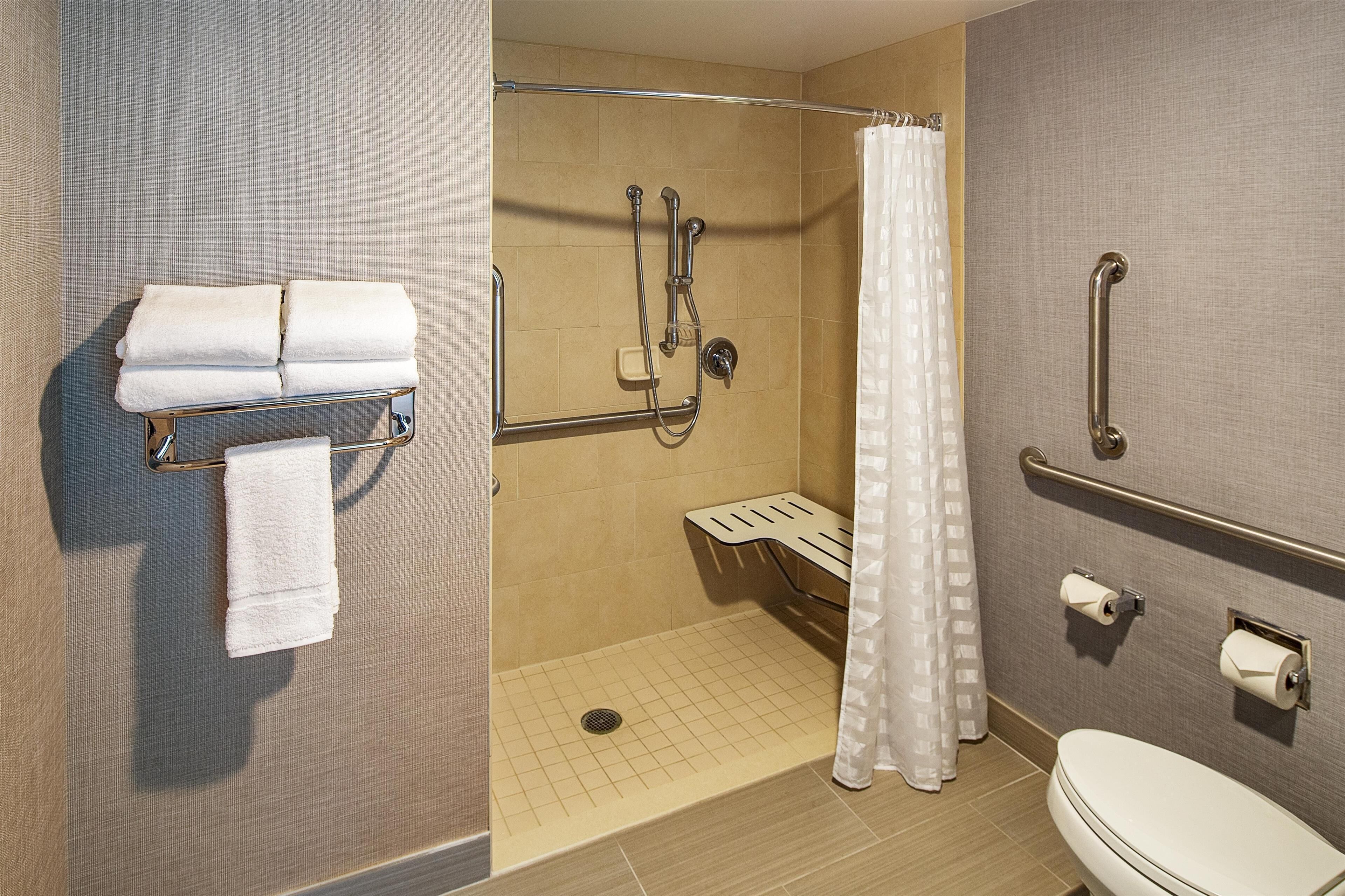 combined shower/bathtub, designer toiletries, hair dryer, towels