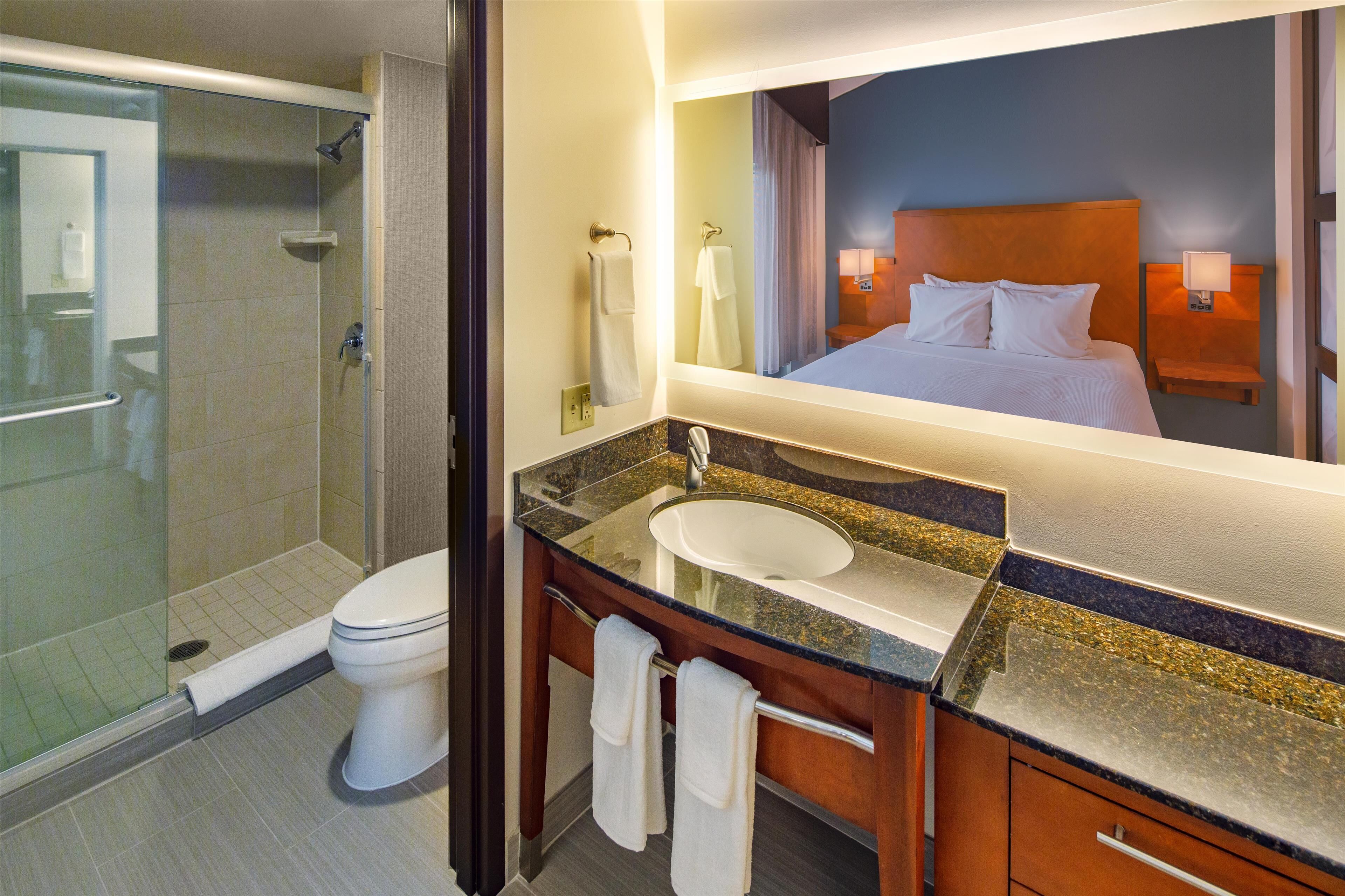 combined shower/bathtub, designer toiletries, hair dryer, towels