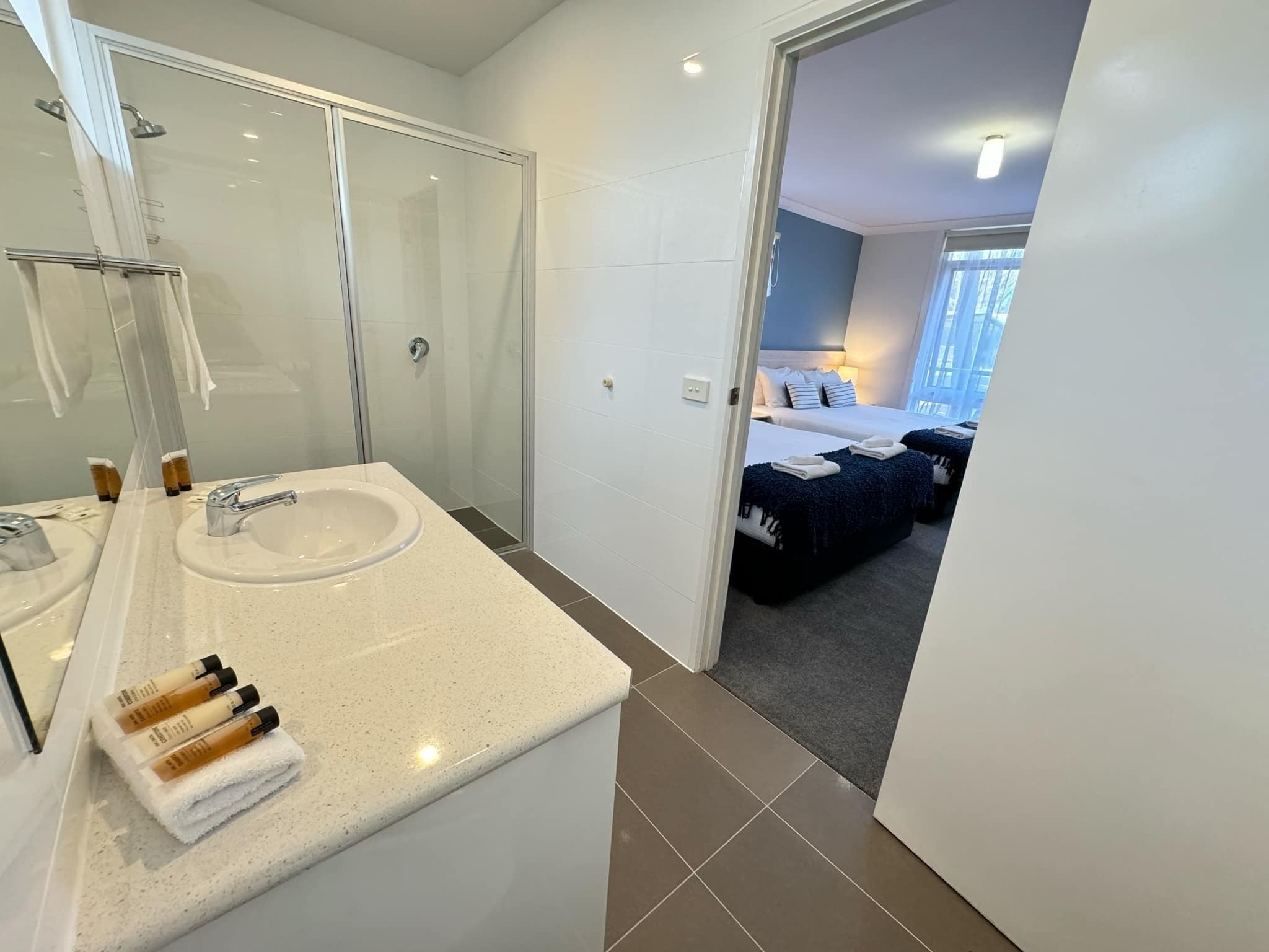 family room with two queen beds | bathroom | free toiletries, hair dryer, towels, soap