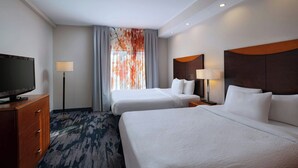 A hotel room with two beds, a TV, a desk, and a window with curtains. - Fairfield Inn & Suites Tulsa South Medical District (Tulsa)