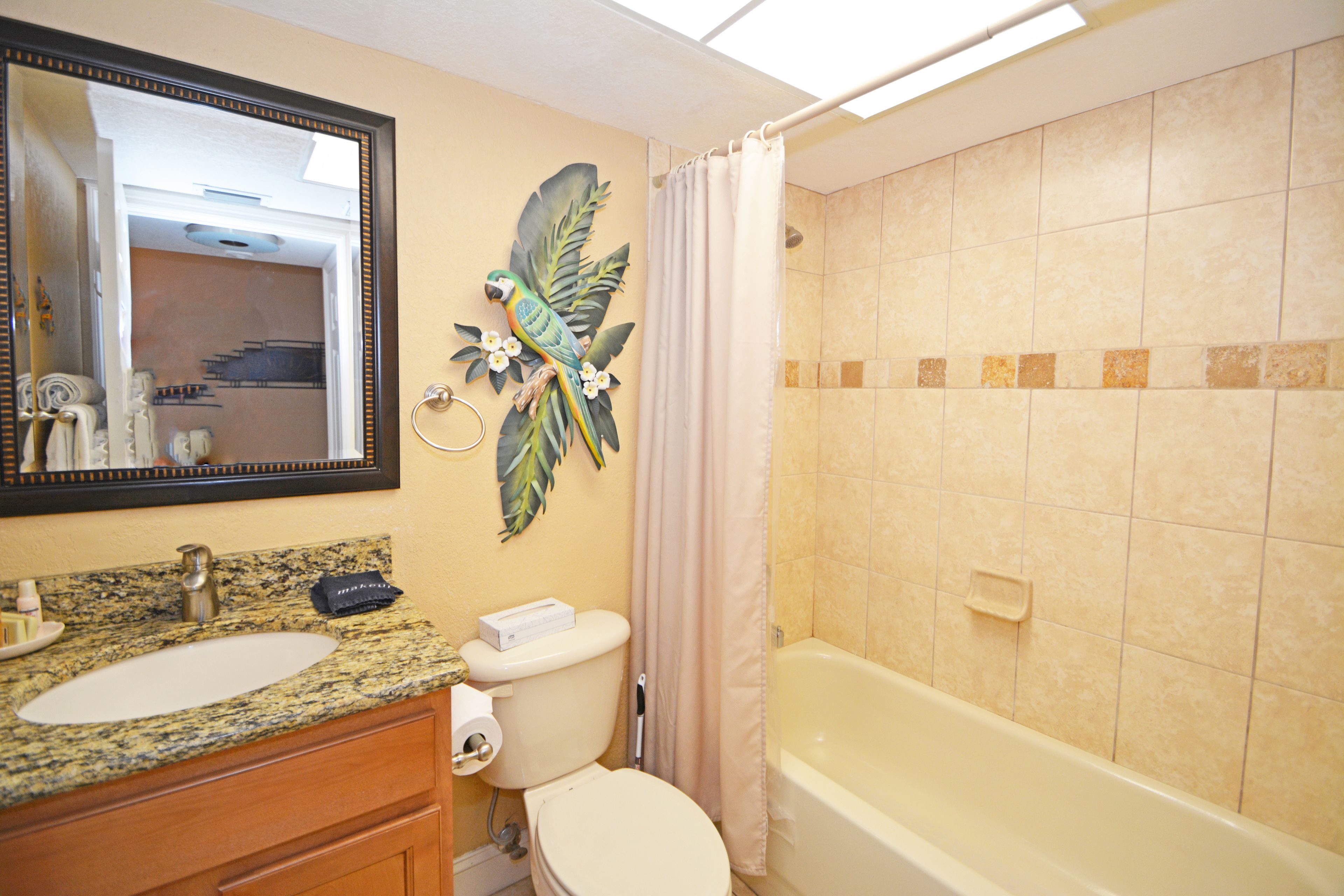 A bathroom with a sink, toilet, and bathtub.