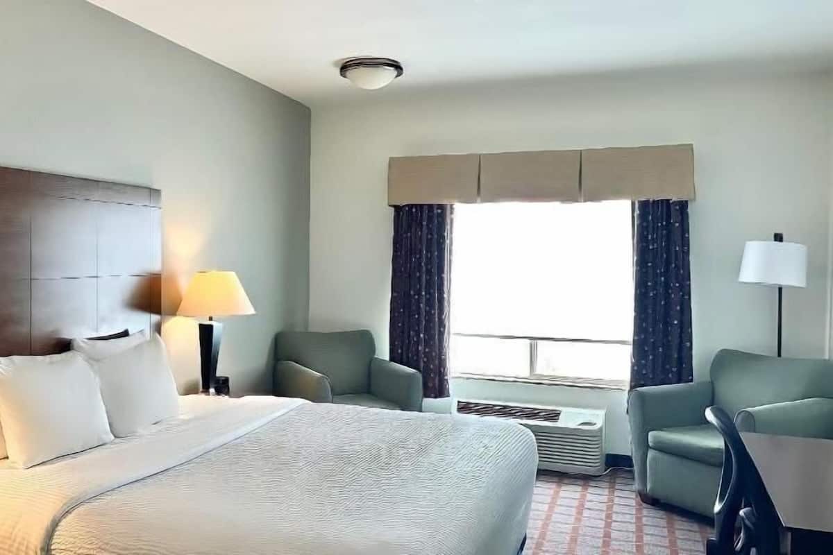 Premium bedding, desk, laptop workspace, blackout drapes