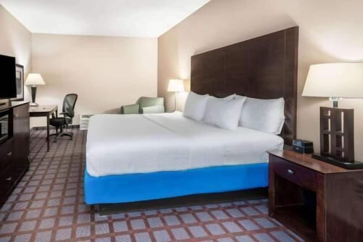 Premium bedding, desk, laptop workspace, blackout drapes