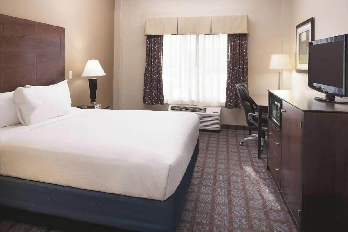 Premium bedding, desk, laptop workspace, blackout drapes