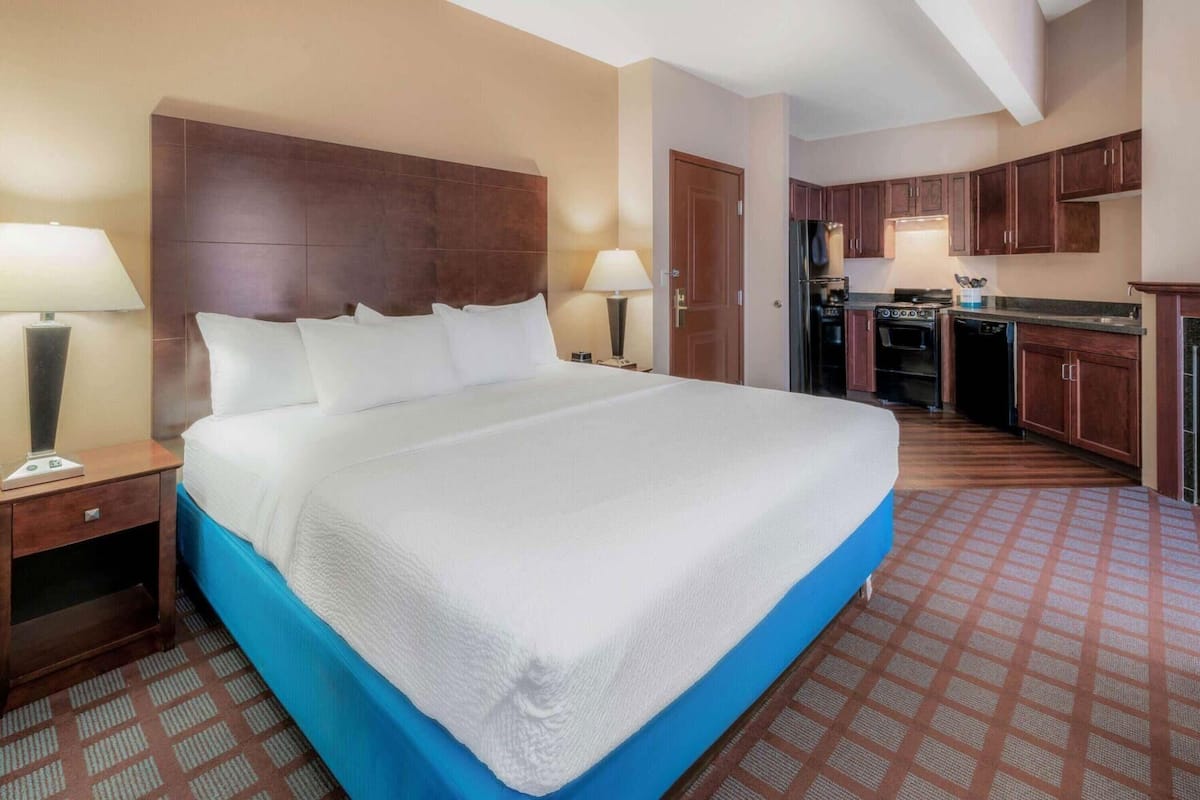 Premium bedding, desk, laptop workspace, blackout drapes