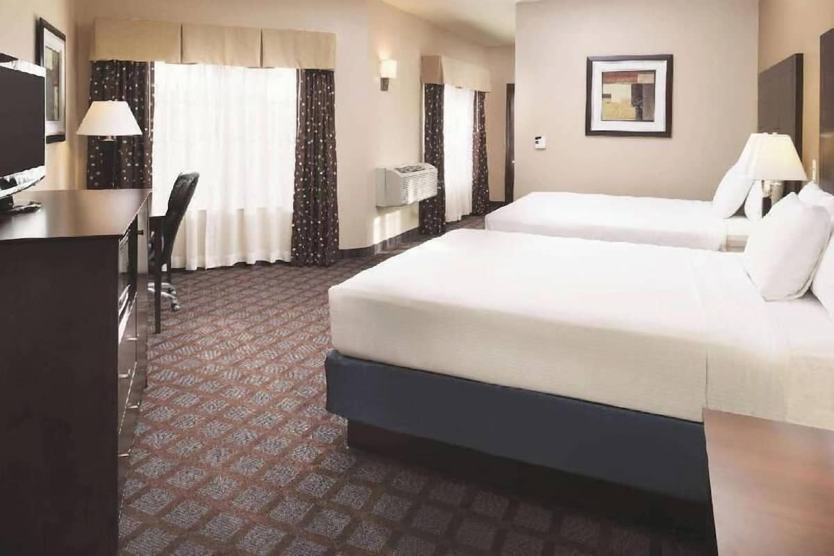 Premium bedding, desk, laptop workspace, blackout drapes