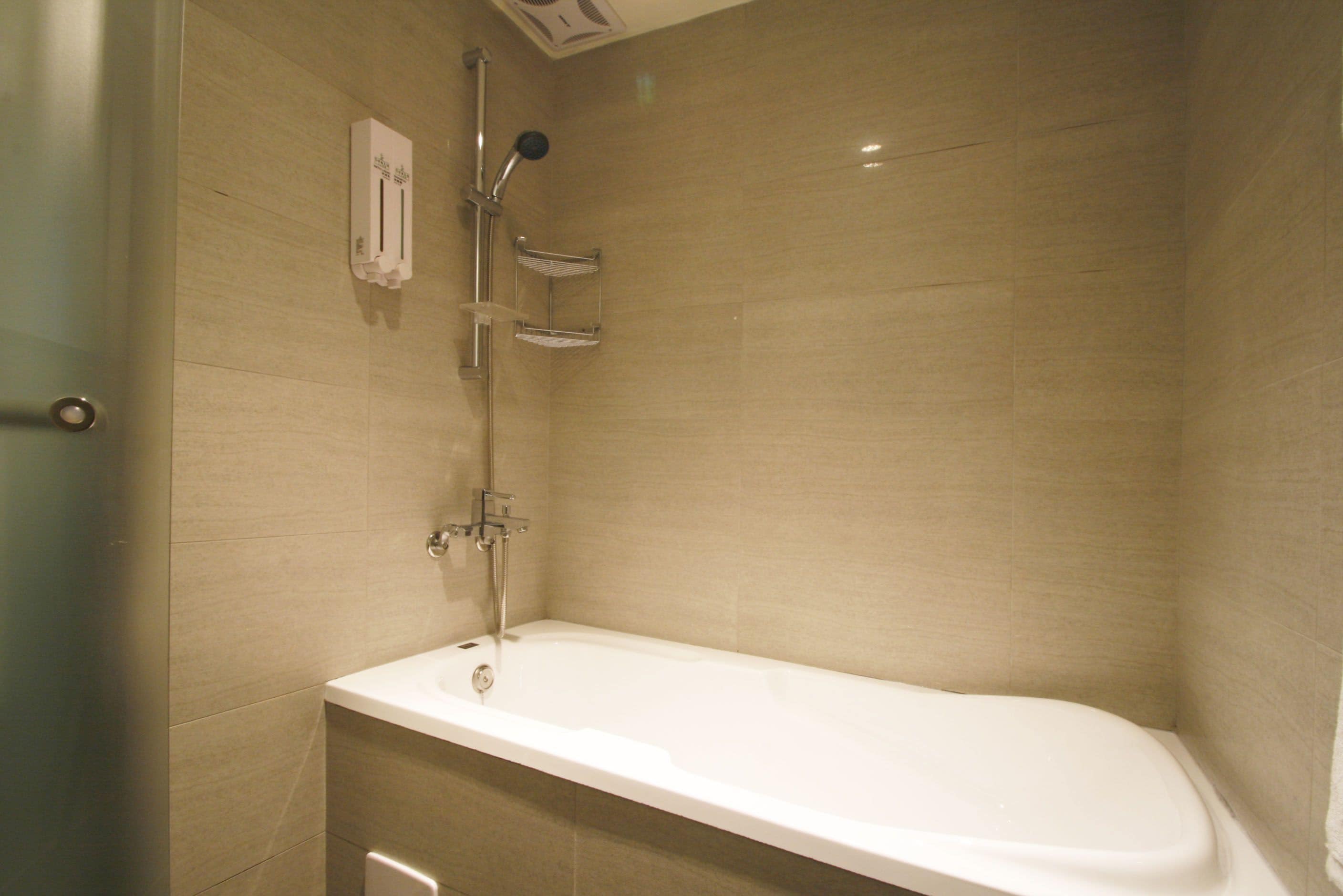 standard double room | bathroom | shower, hair dryer, slippers, towels