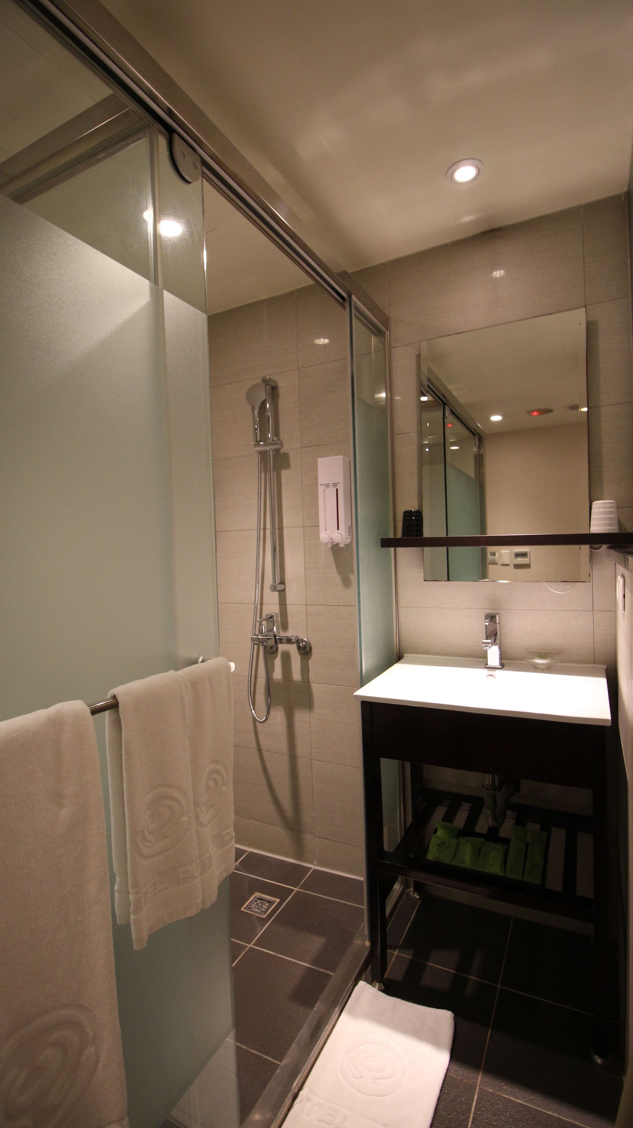 shower, hair dryer, slippers, towels