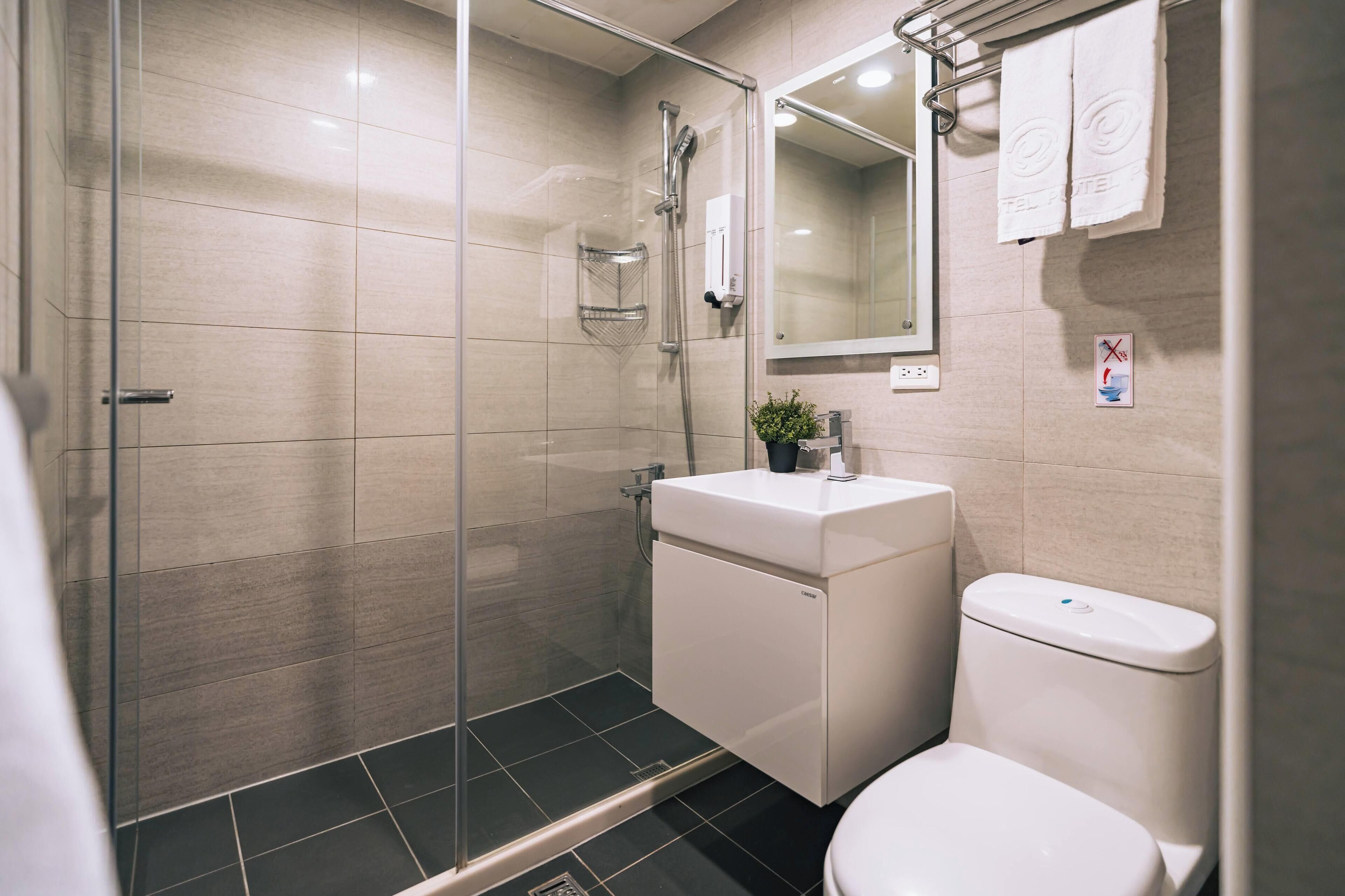 shower, hair dryer, slippers, towels