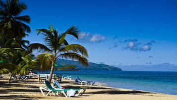 On the beach, sun-loungers, beach towels, beach bar