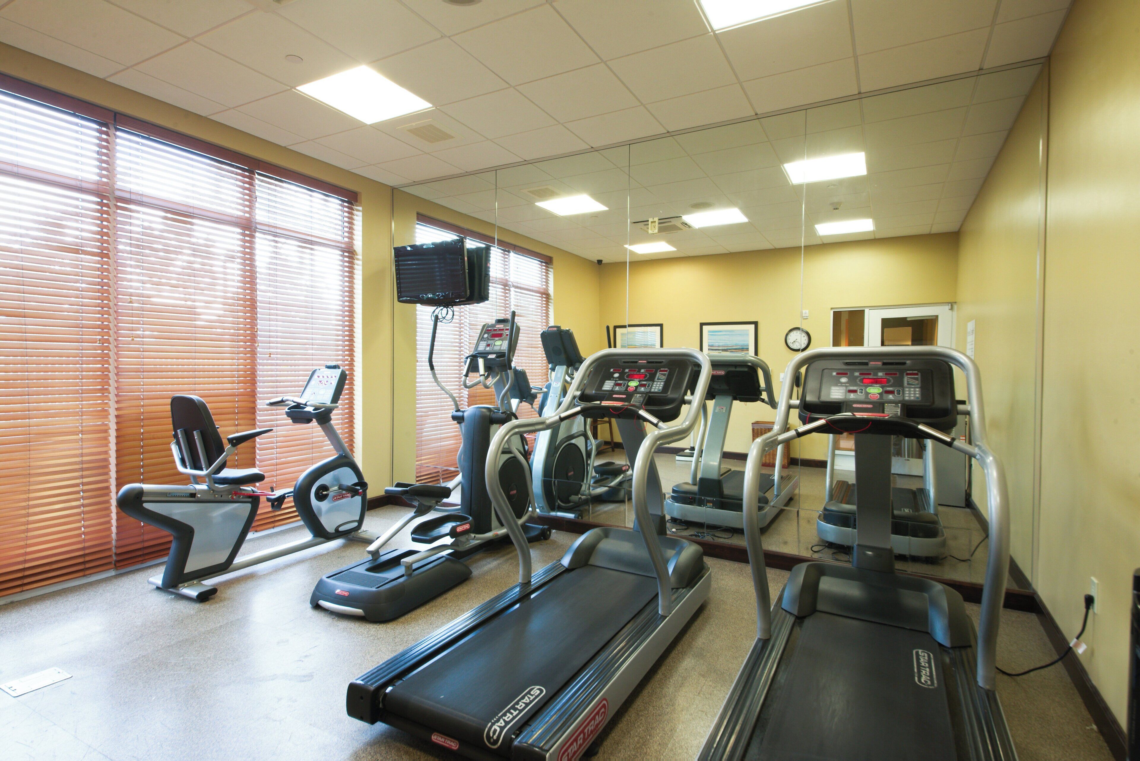 A fitness center with treadmills, an elliptical, and a stationary bike.