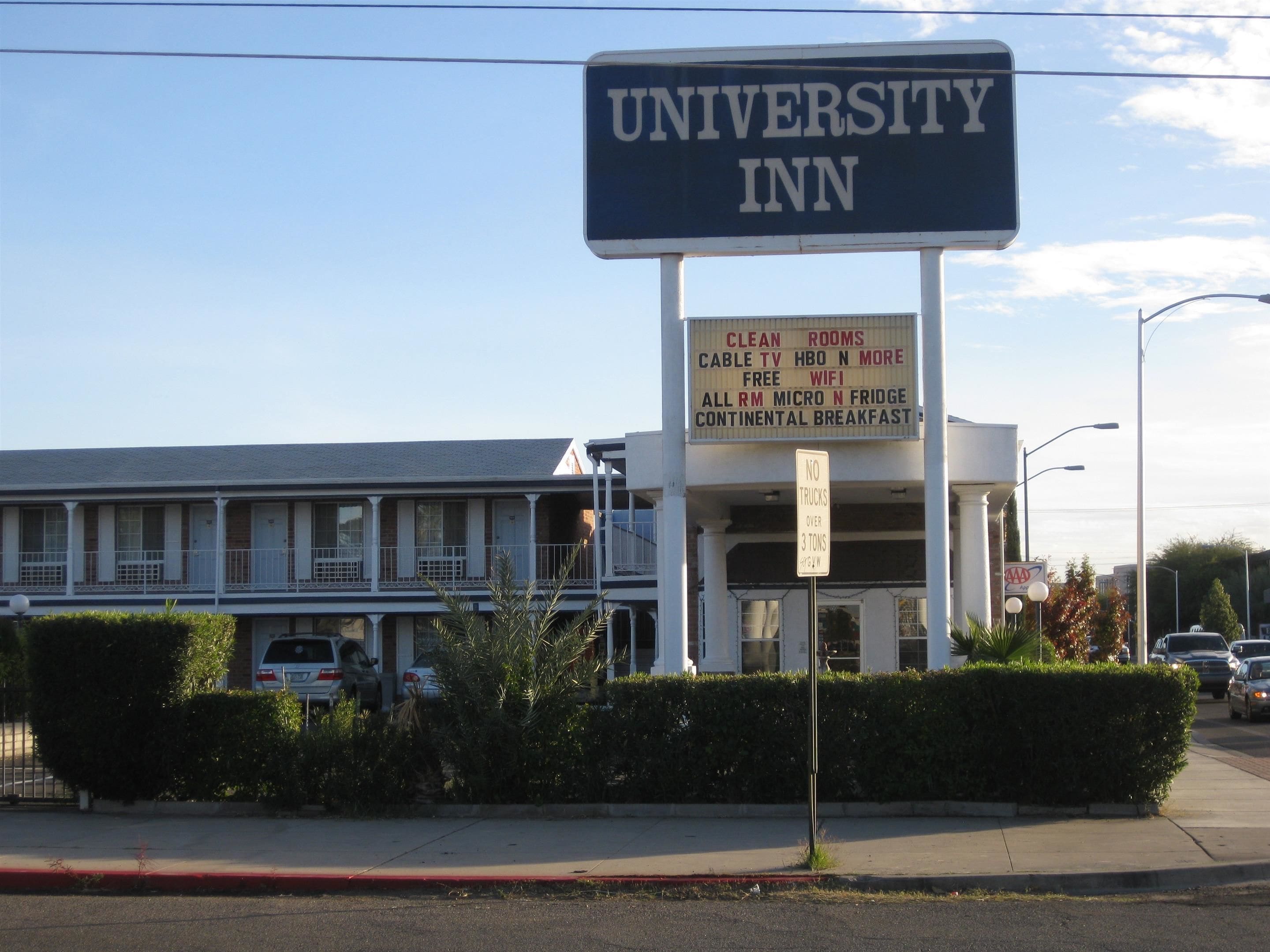 A University Inn sign with amenities listed, including clean rooms, cable TV, HBO, and more.