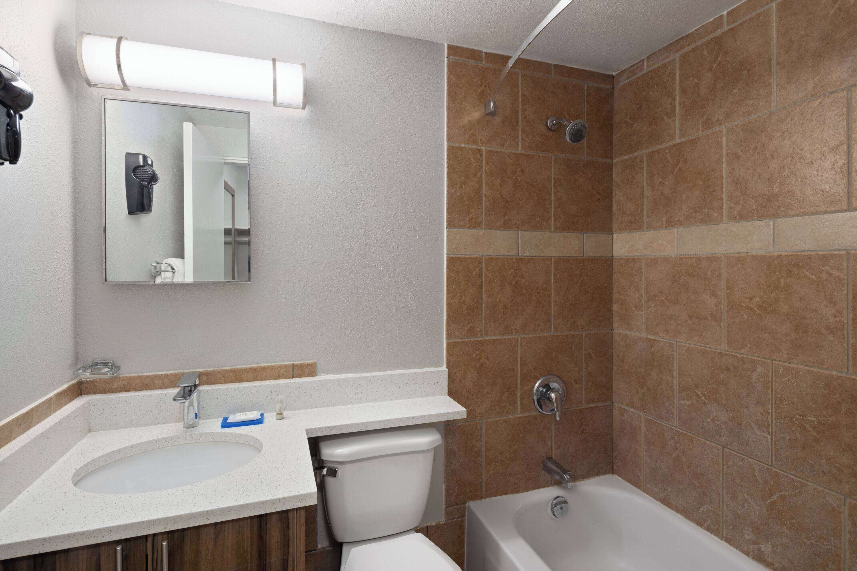 A bathroom with a sink, toilet, and bathtub.