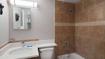 A bathroom with a sink, toilet, and bathtub.