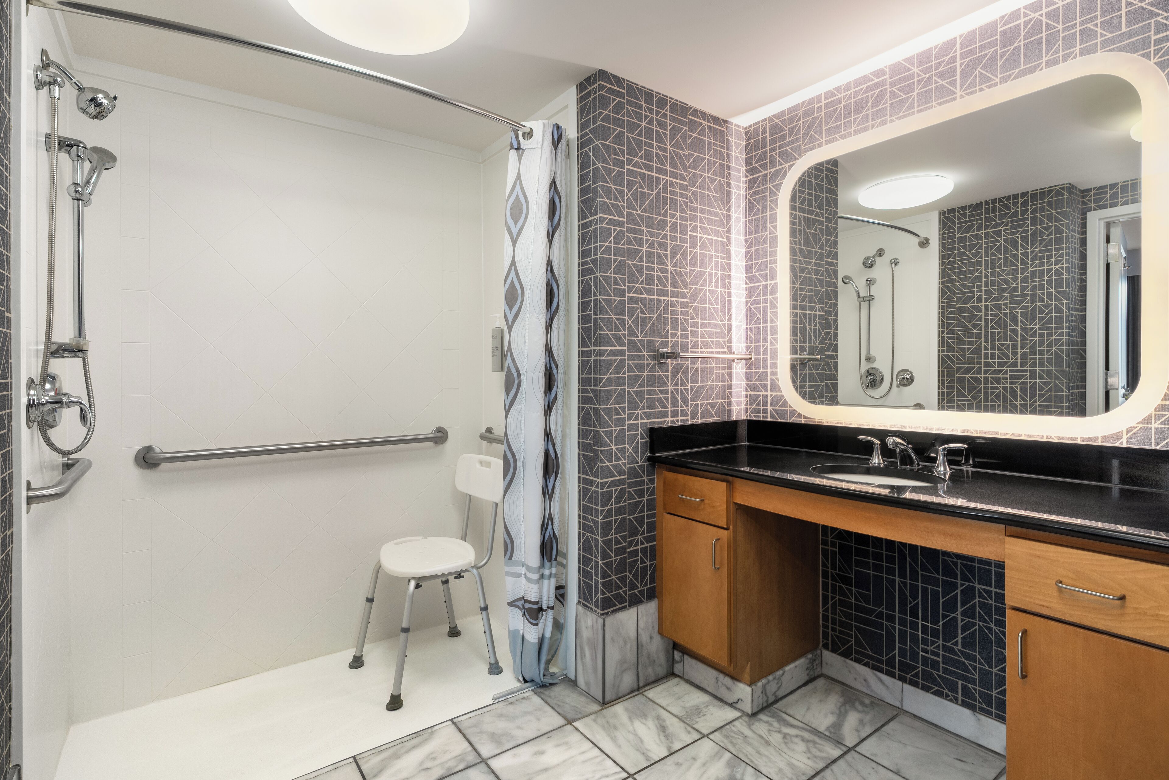 A modern bathroom with a shower, a toilet, and a vanity with a mirror.