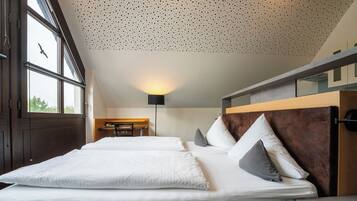 A modern hotel room with two beds, a desk, and a large window.