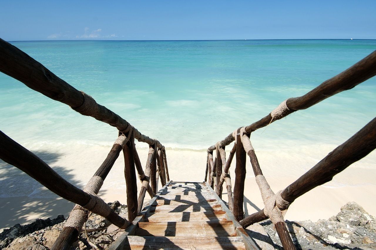 On the beach, white sand, sun loungers, beach umbrellas