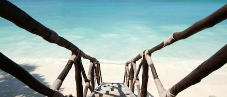 On the beach, white sand, sun loungers, beach umbrellas
