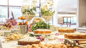 A buffet table with various desserts and a decorative glass centerpiece. - Resort Grande Baia (San Teodoro)