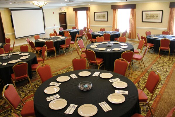 A conference room with multiple round tables, each set with plates, cutlery, and a centerpiece. - Hilton Garden Inn Houston West Katy (Katy)