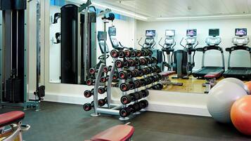 A gym with exercise equipment, treadmills, and weight machines.