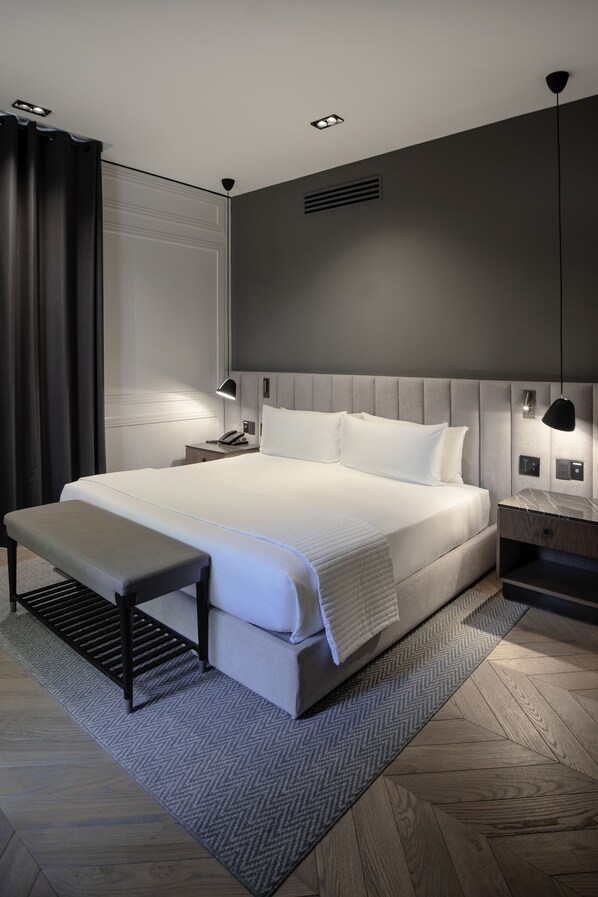 A modern hotel room with a large bed, bedside tables, a bench, and a large window with curtains. - Brick Hotel - Small Luxury Hotels of the World (Mexico City)