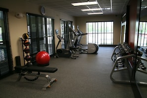 Stay fit on the go with our fully equipped gym featuring treadmills, a bench press, and dumbbells.