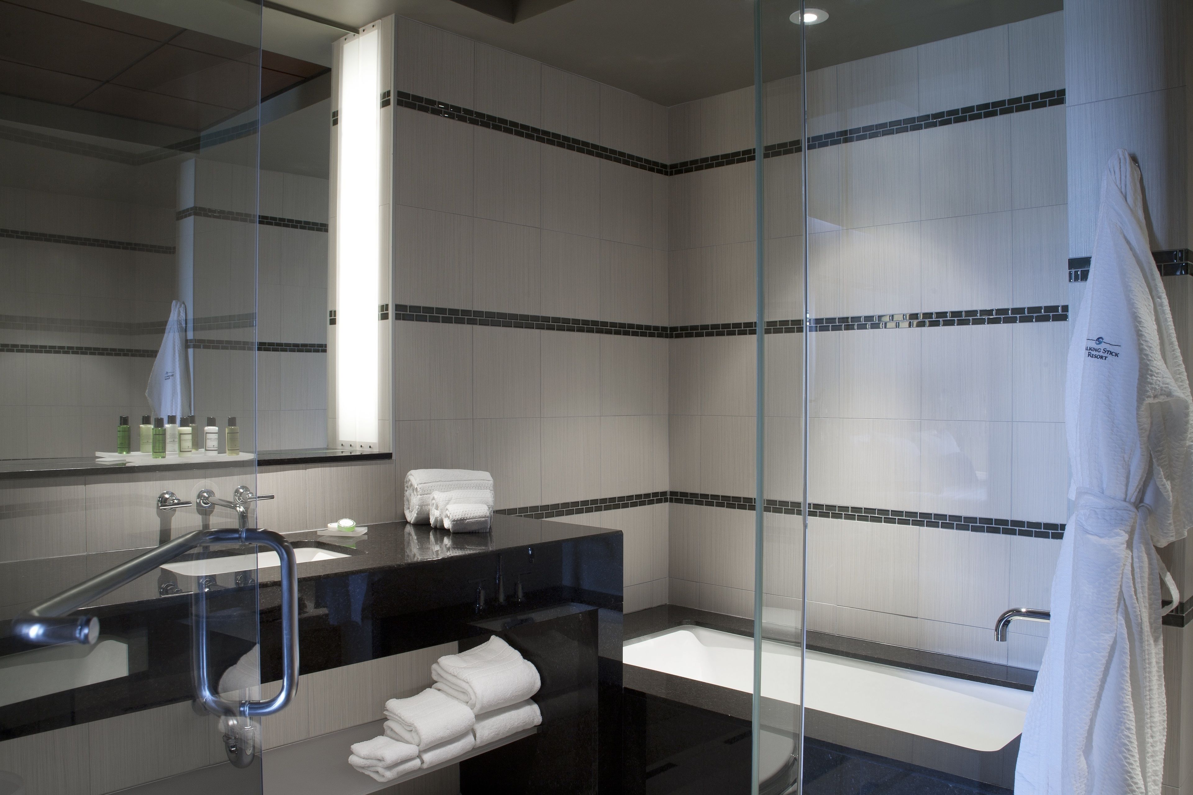 designer toiletries, hair dryer, slippers, towels