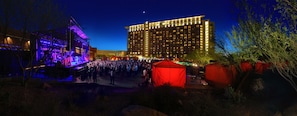 A large hotel with multiple floors and a crowd gathered outside.
