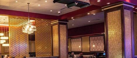 A Grand Café with a modern interior, including a reception desk and seating area.