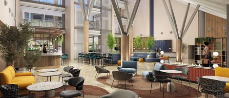 A spacious lobby with high ceilings, modern furniture, and a central seating area.