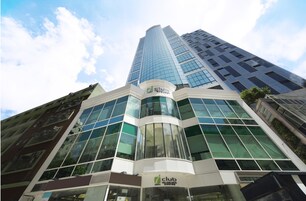 A modern building with a glass facade and a sign reading "Club International Hotel".
