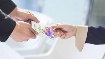 A person handing over a card to another person.