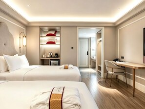 A hotel room with two beds, a desk, and a wardrobe. - Mercure Xian Dayan Pagoda (Xi'an)